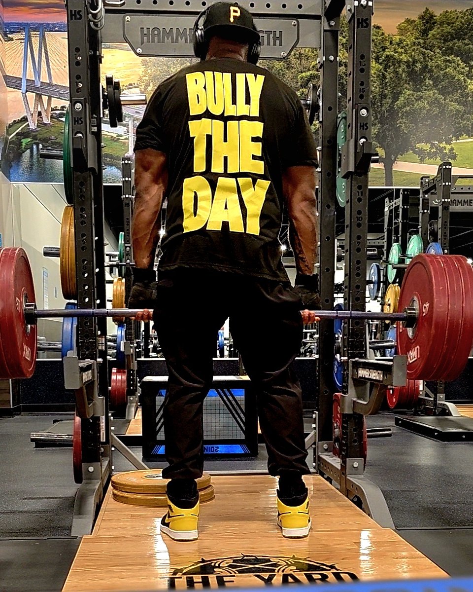 Classic Tee, back: Bully The Day in yellow, set up for a deadlift at The Yard